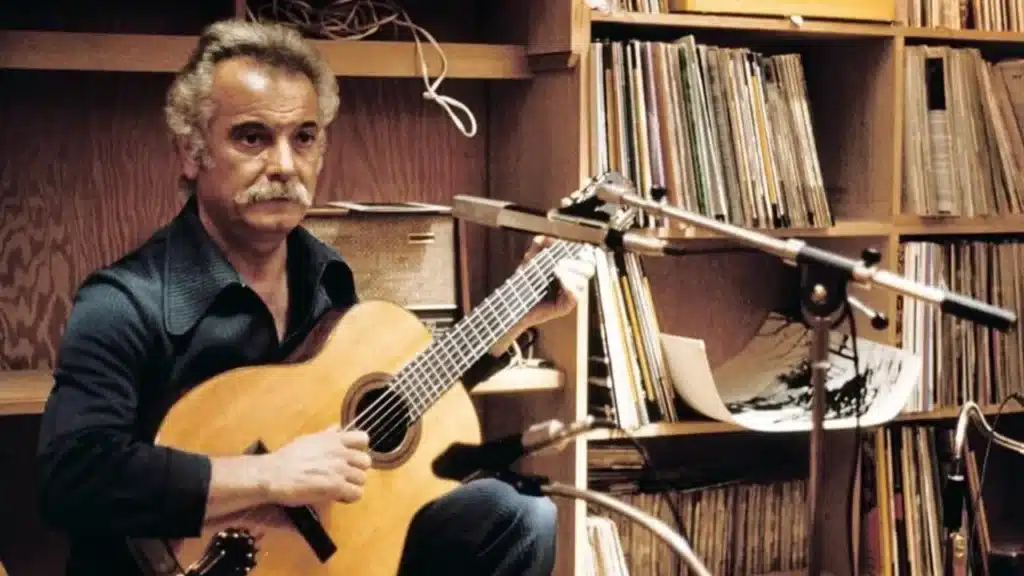 Georges Brassens dans son studio d’enregistrement avec sa guitare, symbole de la chanson française poétique et intemporelle.