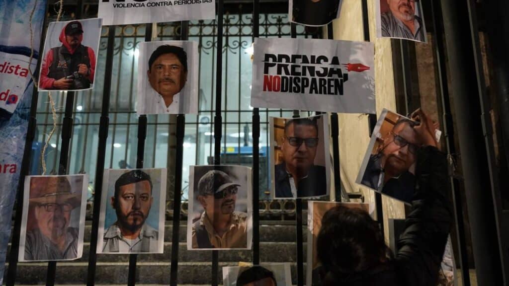 Photographies de plusieurs journalistes affichées sur une grille métallique, avec une pancarte en espagnol indiquant « Prensa no disparen » (« Presse, ne tirez pas »), lors d’une manifestation pour la liberté de la presse.