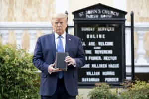 Trump tenant une Bible devant une église illustrant la place de la religion dans la politique aux États-Unis
