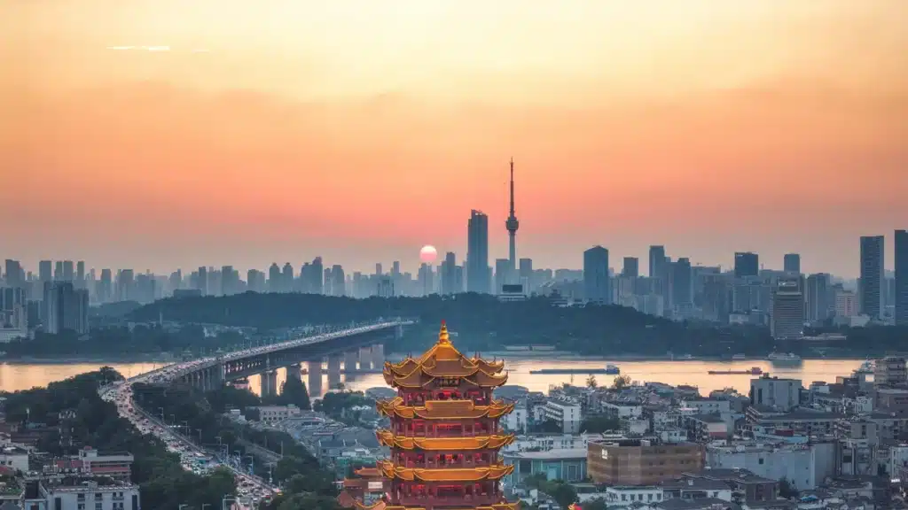 Skyline chinoise au coucher de soleil avec temple traditionnel au premier plan, paysage urbain et culturel de Chine